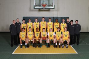 The boys’ varsity basketball team after the season. On the sides are the coaches of the team. The varsity went 9-5 last year. Photo courtesy of McDaniel’s photography.