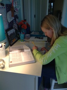    With a schedule of all accelerated classes, Latin four, band, and student council, Augustin manages her time. She gets her assignments done between marching band, jazz band, choir, bells and creative writing.  Here she works on her homework for history. Photo courtesy of Isabelle Augustin.