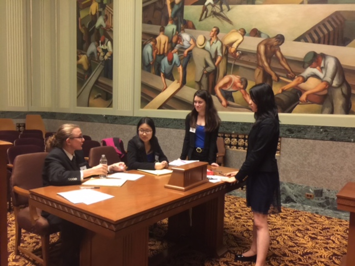 TEAMWORK.+The+Sycamore+Justice+League+goes+over+last+minute+notes+just+before+juniors+Jenna+Bao+and+Ryan+Tufts+compete+in+a+preliminary+round+at+the+Ohio+Supreme+Court.+%E2%80%9CI+had+so+much+fun%2C+mostly+because+of+the+people+that+were+a+part+of+it.+We+were+really+pressed+for+time+but+that+almost+added+to+the+fun+of+it.+We+could+share+our+stress+with+each+other+and+bond+over+that%2C%E2%80%9D+Tufts+said.