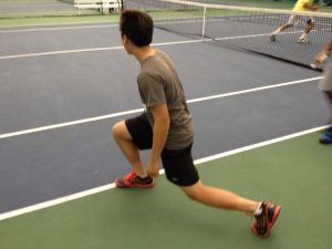 Players like Regis Liou, 9, do lunges during morning conditioning. Coach Mike Teets runs different drills to prepare his players for the upcoming spring season. “[Morning conditioning] keeps me in shape during the offseason,” said Brandon Peck, 12. Photo courtesy of Alex Wittenbaum. 