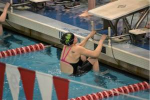 Jory Gould, 10 about to dive in for her 100 backstroke event. She swam this at the Southwest District championships. Gould practiced for the high school and is planning to do so again this. Photo courtesy of Jean Wu. 