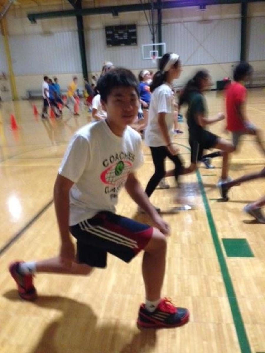 Regis Liou, 9, works hard to train for the upcoming spring season. Behind Regis is the large, hardworking tennis team. The Gregory Center is one of the foundations of the tennis team’s success, because they train there.