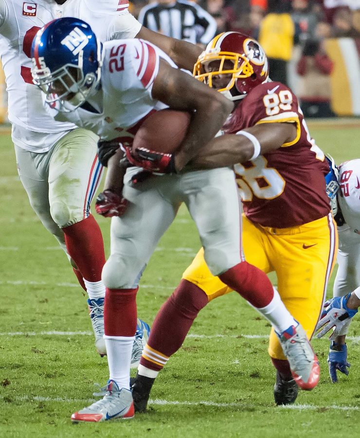 Redskins wide receiver Pierre Garcon tackles New York Giants safety Will Hill. In a picture that sums up the Redskins season on and off the field, the Garcon is switching roles with the defender after a turnover
PHOTO CREDIT: MCT PHOTO