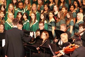 Bella Voce is the academic all-girls choir. They perform solo, but they often team up with the Aviator Chorale or Select to get a fuller, more complete sound. Bella always wear their signature long green dresses, which were newly bought this year to replace their older version. Photo Courtesy of: McDaniel's Photography