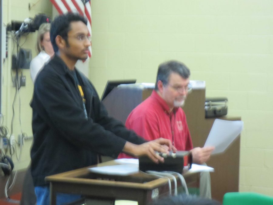 Pavan Nimaganda, 11, handles the buzzers while Coach Clark reads the questions. 