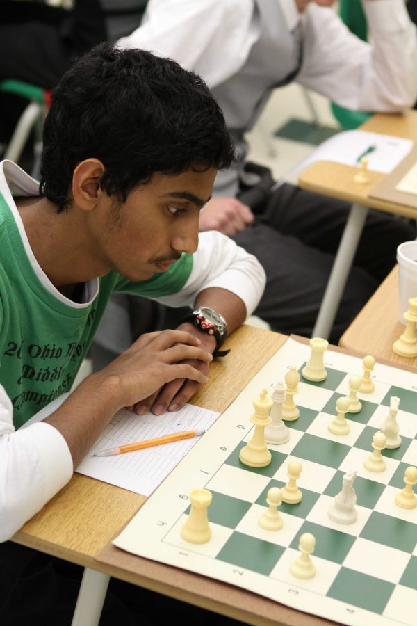 Divyesh Balimurali, 10, the first board, calmly studies his pieces, formulating some method of attack. 