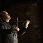 Christian Howes playing his “Phoenix.” Electric violins are obviously not the same build as acoustics, and they have no wooden body. The amplifier is relied on to carry the sound of the instrument, so without an amp, electric instrument is relatively quiet. 