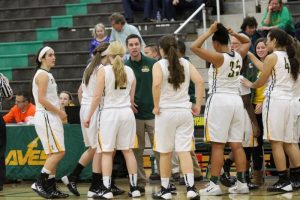 Coaching in the huddle, Derek Christerson, Varsity head coach, explains the strategies the team should execute to improve their score. The Varsity team competed against the Princeton Vikings on senior night. Throughout the course of the season, the players grew very close as teammates and also as friends. Photo courtesy of McDaniel’s photography.