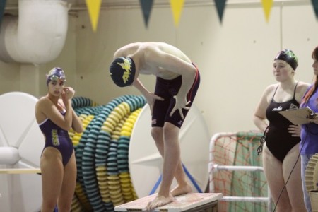 Eamund Bell, 10 prepares to dive in for his race. Bell practices with the Cincinnati Marlins outside of the high school season. There are four sites of the Marlins and he trains at the East site or the Sycamore site. (Photo courtesy of McDaniel's photography)