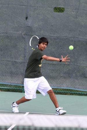 Rohan Dsouza, 10, sets his feet to meet a ball with a forehand. Dsouza plays year-round tennis at Camargo Racquet Club, and feels excited and determined for this year’s tryouts. “Well obviously I have personal goals that I want to meet regarding how I perform, but as always I know that no matter what it’s about to be an awesome experience. It’s really a cool opportunity to play for Sycamore. Even if it is a little harder to make the teams,” said Dsouza. Photo courtesy of McDaniel’s Photography. 