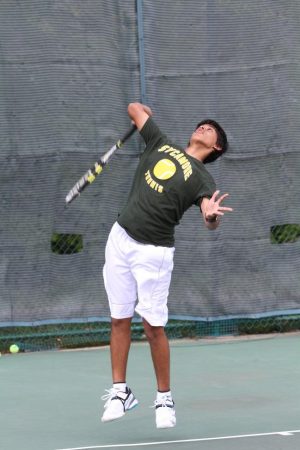 Rohan Dsouza, 10, explodes upwards for a serve. “This year is going to be great. I can’t wait to bond with my bros,” said Dsouza. Tennis tryouts will begin on Mon., Mar. 10 at Western & Southern. Photo Courtesy of McDaniel’s Photography.  