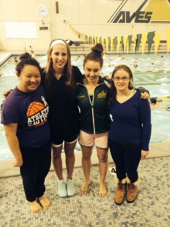 Bryn Cole, Jordan Elder, Gina Schwegmann and Stephanie Gunter all celebrate the last meet they will have together during their senior night meet at their home pool.     “ Senior night for any sport is very special. It’s also bittersweet.  Mostly sweet because the parents set up the senior recognition ceremony wonderfully and provide a yummy cake and the energy of the swimmers, coaches, family and friends combined make the night exciting and a fun way to end your high school swimming career.” said Schwegmann,12. Photo courtesy of Lauren Shassere. 