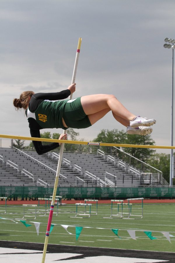 Molly Gearin, 11, vaults over seven feet at the Greater Miami Conference Championships. She and I have been pole vaulting teammates since our eighth grade year- the year the pole vaulting program was brought back to SJHS. Fear in competition is a constant obstacle to overcome. It is the mental and emotional strength of the individual that pushes the fear aside to achieve success.
Photo courtesy of McDaniel’s Photography.