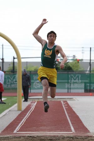 John Vuotto, 12, launches himself into the air in the long jump. He finished third with a jump of 21 feet, six and one quarter inches.
