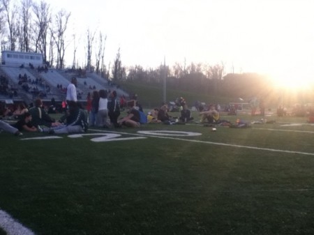 Athletes stretch and socialize on the field at the Mount Healthy Invitational. The meet ended up going late into the night after a series of misunderstandings with the time clocks and start guns. Nonetheless, the competitors showed up to practice the next day- on which there was no school- at the scheduled time of 9:00 am. Photo courtesy of Tori Swart