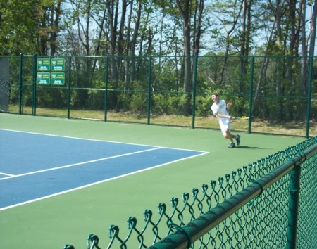 Brandon Lombardi, 11, strikes a forehand crosscourt during the Coaches Classic Victory. The JV tennis team won first place in four out of the five departments, and completed the season with an undefeated record. Lombardi, with Aravind Murali, 10, lost a tough match against Indian Hill in the preliminary rounds. Photo courtesy of aves10s.net. 