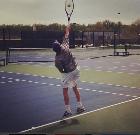 Jack Loon, 9, jumps up for a flat serve down the tee. Loon won his match at third singles with a final score of 6-2, 6-2, securing the team’s 5-0 victory. This was the team’s first legitimate home match of the season. Photo courtesy of Jack Loon. 