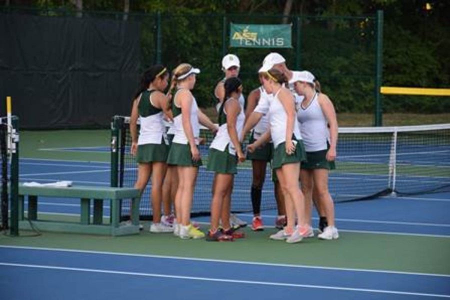 The Lady Aves tennis team huddles after a match win earlier this season. They lost to Ursuline in a very close 2-3 match. They are now out of the state team tournament.