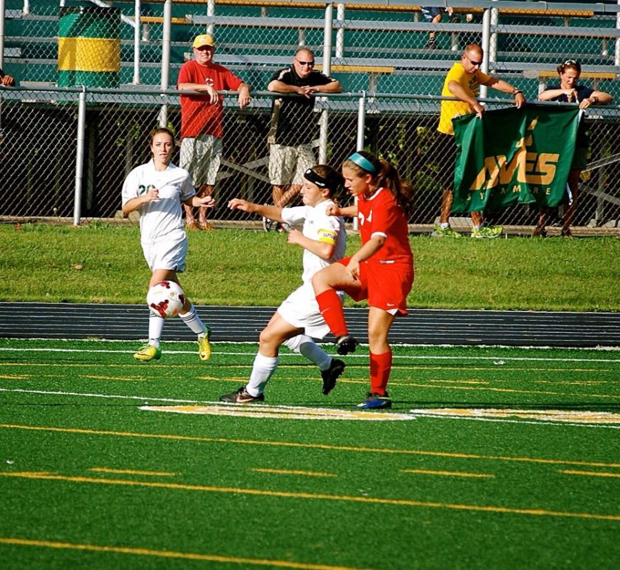 Sophomore Nicole Crone and freshman Zoey Goldenburg as they defend their home turf. Crone is going in for a kick on the ball. Goldenburg is waiting along the sides for a pass from her teammate. 