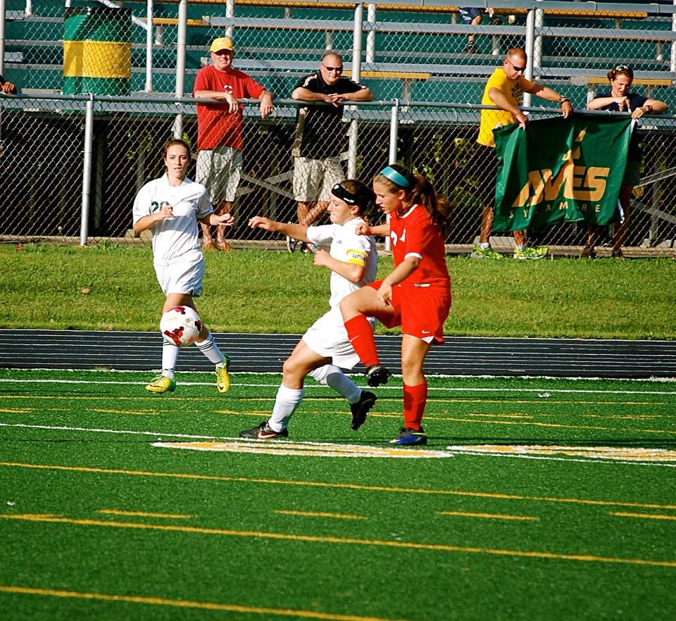 Sophomore Nicole Crone and freshman Zoey Goldenburg as they defend their home turf. Crone is going in for a kick on the ball. Goldenburg is waiting along the sides for a pass from her teammate.