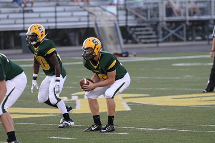 Sophomore quarterback Jake Borman (#10) takes the snap in a game against Ryle. Junior running back Clarence Dawsone (#20) also sets up to block alongside Borman. Dawson has almost 600 rushing yards over seven games this season.