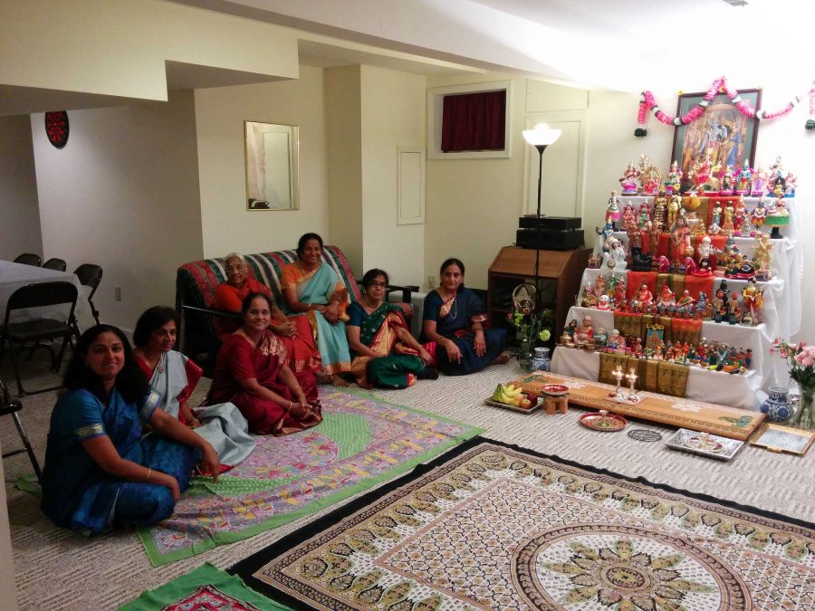 Women and girls traditionally sit on the floor, facing the dolls. People can come up and sing traditional Indian songs. The family and friends attending also wear traditional clothing. 