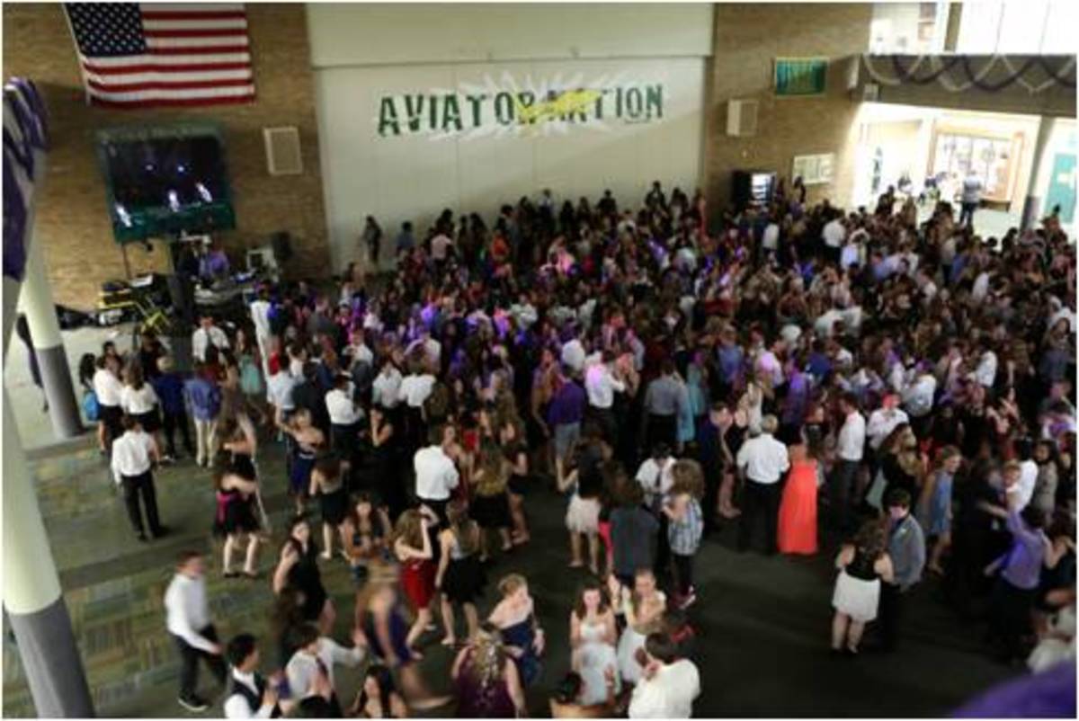 The floor of the commons was packed with students during the Homecoming dance. New features this year included a coat checking option where students could store their bags and shoes in the gym, if desired. However, old changes, like the locker bay areas being completely shut off, were kept in place this year. 