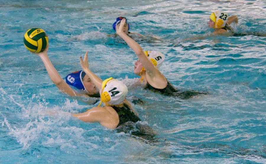 Sophomores Laura Setser and Sarah Horne work together to block the goal.  They both get high out of the water and each take a side of the player so that the goalie can protect the middle of the goal. By working together, the team becomes a bigger threat in the water.