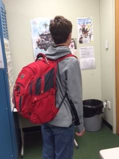 Freshman Max Snyder carries his backpack after the bell rings. Freshmen, along with other grades all have suffered from heaving heavy backpacks around. However, Obama has been taking steps towards mandating online textbooks, which will hopefully relieve some of the stress backpacks put on students’ backs. 