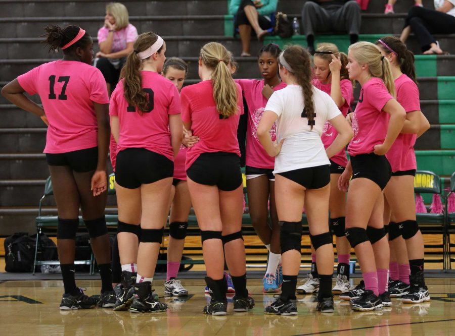 The team is discussing the game during Volley for the Cure on Thurs. Sept. 11. The team went through staff changes over the summer but have a 9-6 record. They compete with each other and try to beat their teammates but come together as one for games.