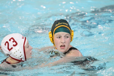 Junior, Sarah Wessinger plays defense against Milford. Wessinger acted as a swing player, meaning that she played for both the Junior Varsity and the Varsity teams. (photo courtesy of McDaniel’s photography)