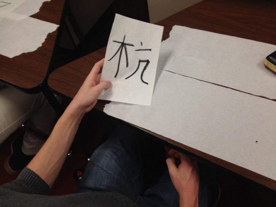 The photo was taken on Calligraphy day in Japanese Club.
Sophomore Jack Pulliam is writing a character that the teacher wrote on the board. All the students in Japanese Club wrote a character which made a phrase.