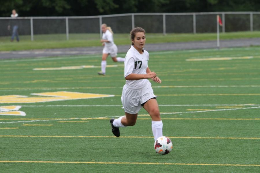 Sophomore Brooke Baker is dribbling the ball downfield for girls’ JV soccer. With the team’s large number of players, time on the field was limited. Although the teammate number was large they were able to bond as one.  
