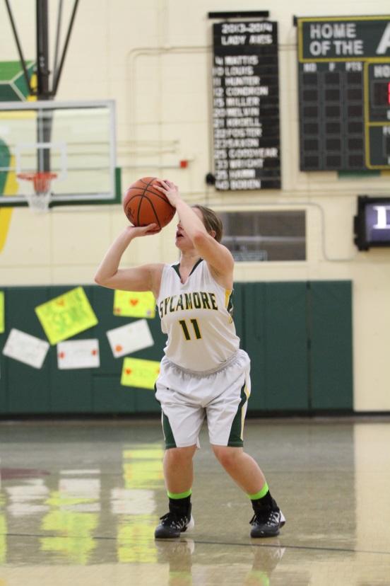 Junior Haley Rayburn is shooting a basket in a JV basketball game last year. Rayburn is now on Varsity for the school after being on JV last year. The GMC changed their name from JV to JVA and freshman teams to JVB. Photo courtesy of McDaniel’s Photography.  