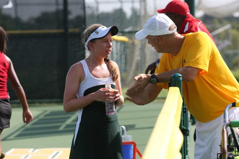 During the changeover, Abele receives advice from her coach Michael Teets.  He motivates her to finish the match strong while she hydrates herself.