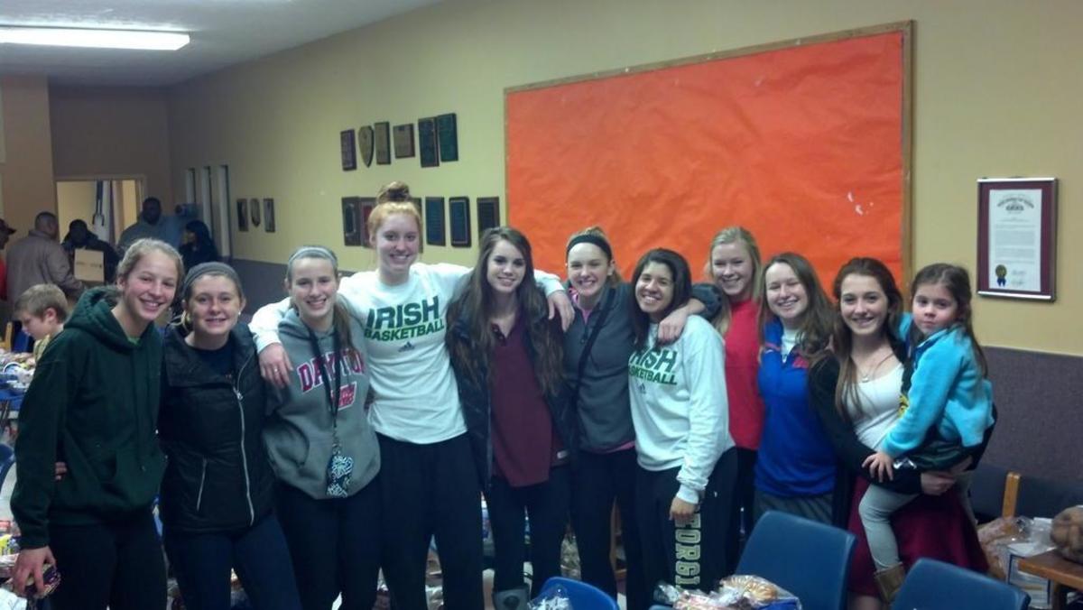 Giving back: Girls basketball players work together on and off the court