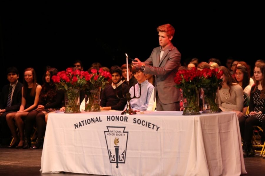 Senior Austin Schaefer lights a ceremonial candle for character which is one of the five traits of NHS members. This lighting is a tradition for NHS initiation. Austin is lighting this candle because he is the president of NHS. 