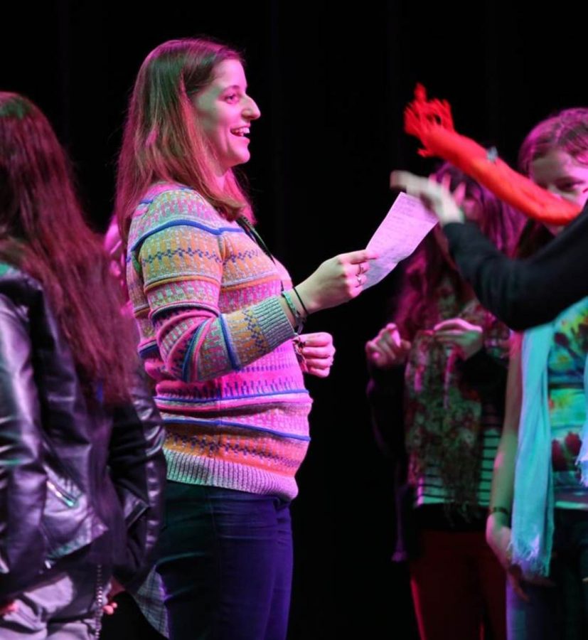 Teacher and director Ms. Sarah Garvey pumps up the cast before performing.
