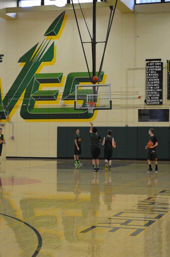 Boys basketball warmed up in the gym before practice began after school. The boys have a game on Friday night at home. Following the game there will be a glow dance in the commons.
