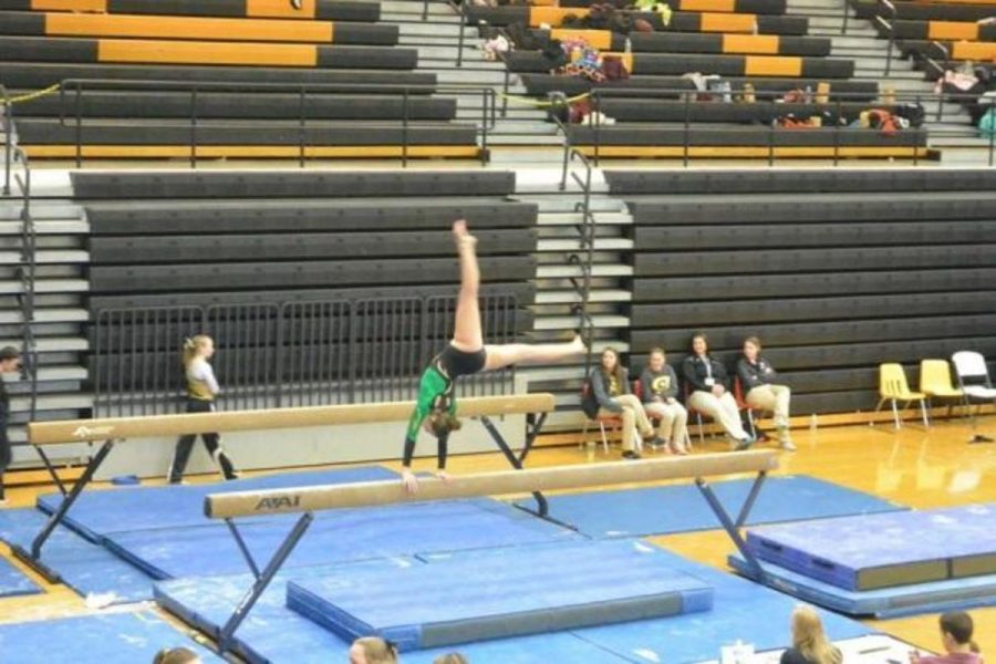 Molly Gearin, 12, competes on the beam at a recent meet in Centerville. As a senior, this is Gearin’s final season after 15 years. Senior night is Feb. 11 at Cincinnati Country Day. Photo Courtesy of Molly Gearin 