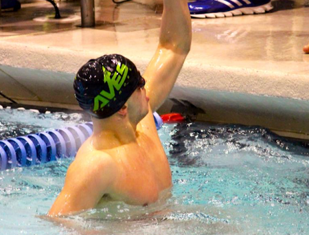 Hancher celebrates after finishing the 400 yard freestyle relay. Hancher anchored the relay. The order of the relay was John Heldman, senior; Rick Niu, senior; Isaac Goldstein, senior; and Hancher. They finished ninth with a time of 3:15.93. Photo by Mary Kay Heldman.