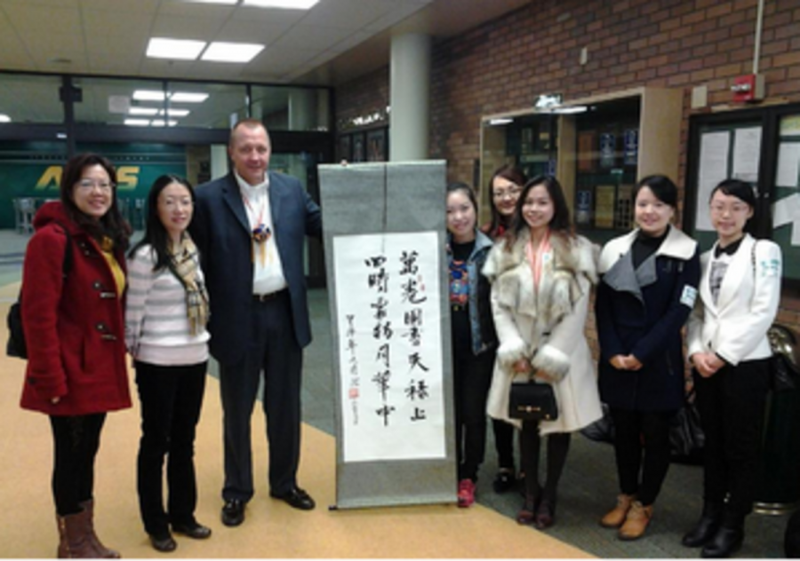 Principal Doug Mader greets several Chinese educators at the front office. The teachers traveled to the United States for five months to learn about the American school system and improve their English. At SHS, they visited several classrooms throughout the day. 