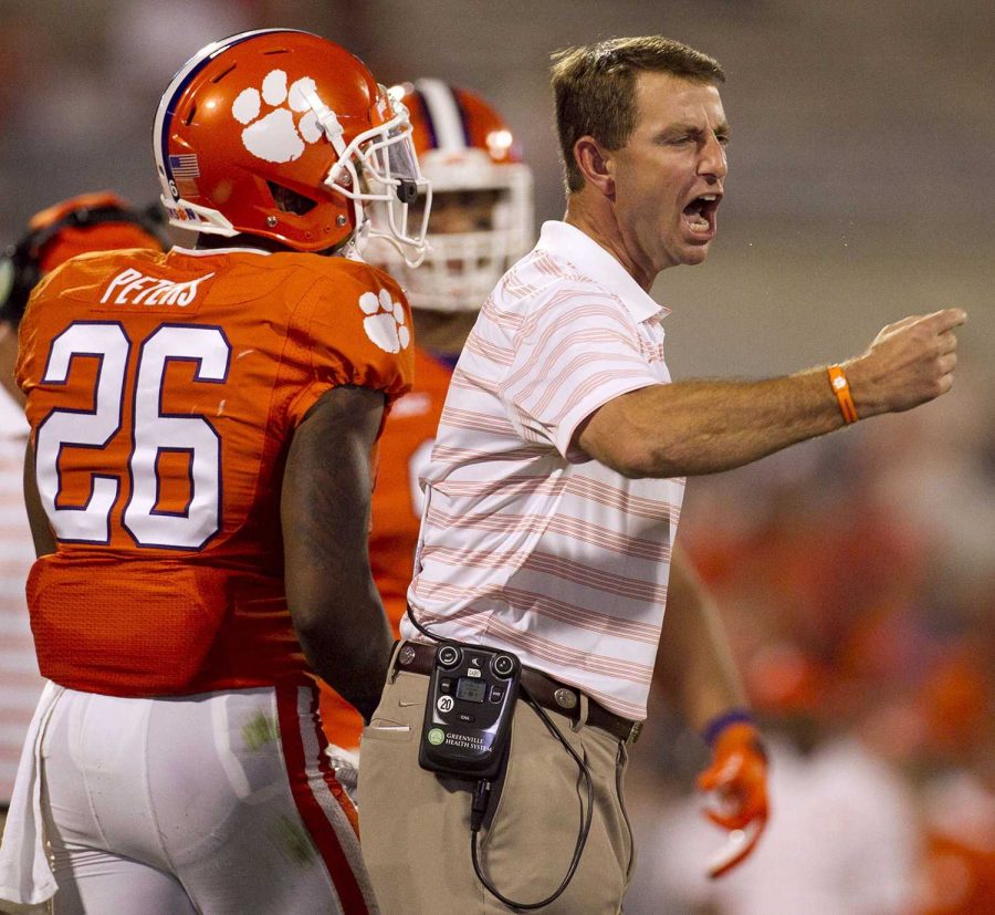 Dabo Swinney coaching during a Clemson game.  Despite a multi-million dollar salary, he does not support benefits for his student athletes. Swinney’s attitude toward collegiate sports remaining “amateur” is not uncommon among coaches. 