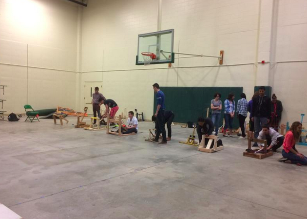 One of the accelerated physics classes tests their catapults in the back gym during class. Students receive one point for getting the beanbag on the board and four for launching the bag into the board’s hole. The final winners will be determined on March 27.