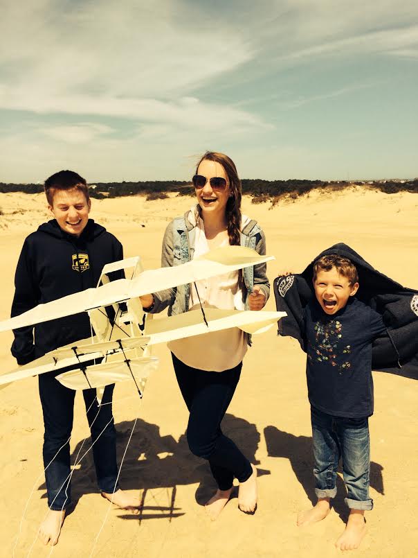 Junior Lauren Shassere and her two younger brothers enjoyed spring break last year on the sand dunes of North Carolina. Here they prepare to fly a plane shaped kite over the sand.