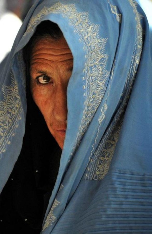 The holiday was celebrated worldwide, although considered controversial in some areas where women are oppressed.  Pictured here is a woman shielding her face while watching the International Womens Day celebration in the Governors compound in Ghazni City, Afghanistan.  Some women in such countries took it as a special occasion to remove their Burkas, but others chose to uphold their religious traditions despite relaxed restrictions.  Photo courtesy of MCT Photo Campus.
