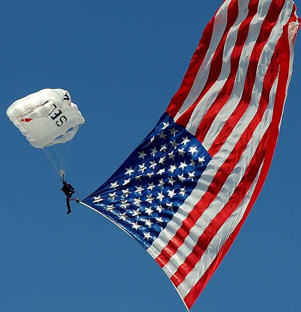 A parachutist brings a large American flag into the infield area at Charlotte Motor Speedway on Sunday, May 24, 2015, prior to the running of the Coca-Cola 600. (Jeff Siner/Charlotte Observer/TNS)