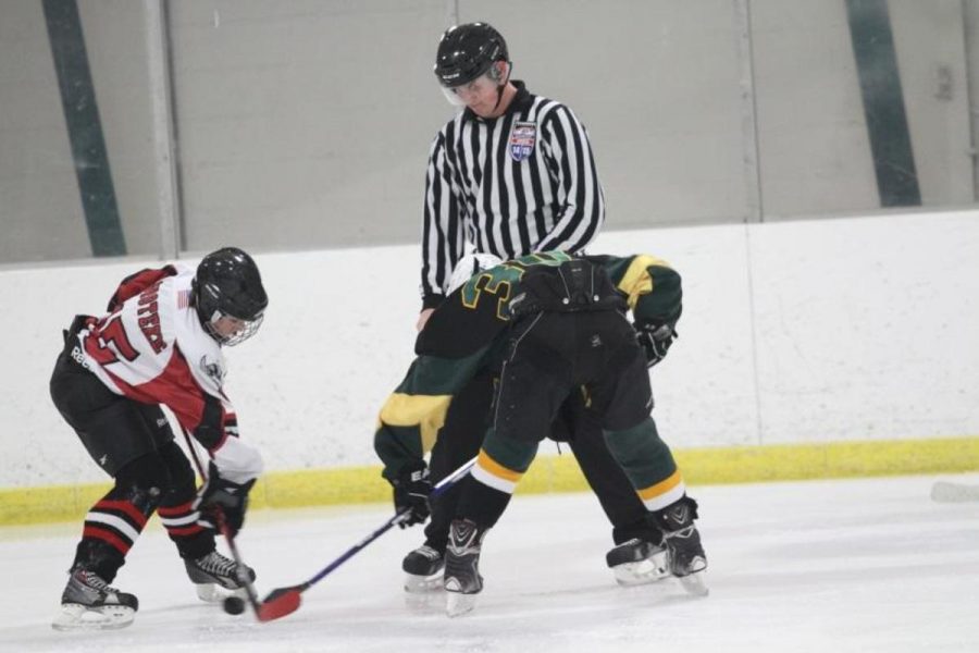Sycamore and Northglenn fight for control in a faceoff. The ref has just dropped the puck. The battle has begun.