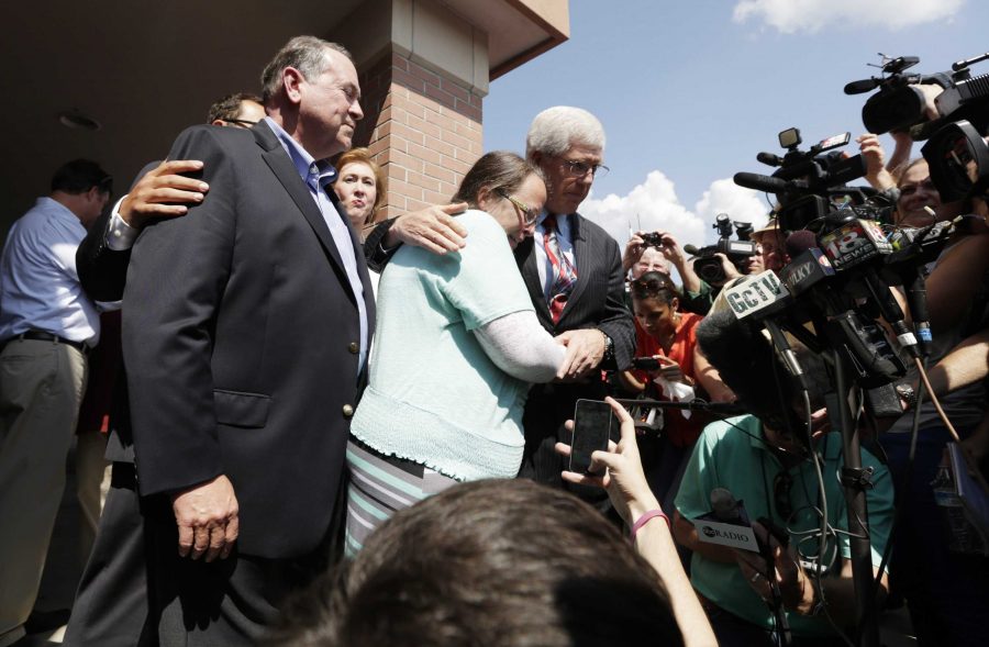 Kim Davis, embraced by her lawyer, Mat Staver, appears before the media with Republican presidential candidate Mike Huckabee, left, outside the Carter County Detention Center in Grayson, Ky., on Tuesday, Sept. 8, 2015. (Pablo Alcala/Lexington Herald-Leader/TNS)