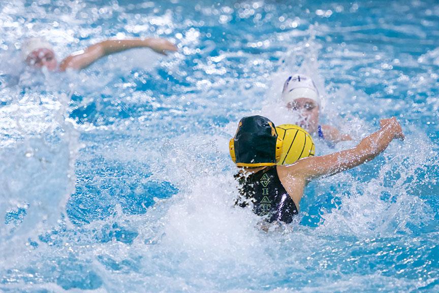 Senior Paige Parr is swiming off for the ball. This is Parr’s second year on water polo, along with her second year on Varsity. Her cap number is number 4.